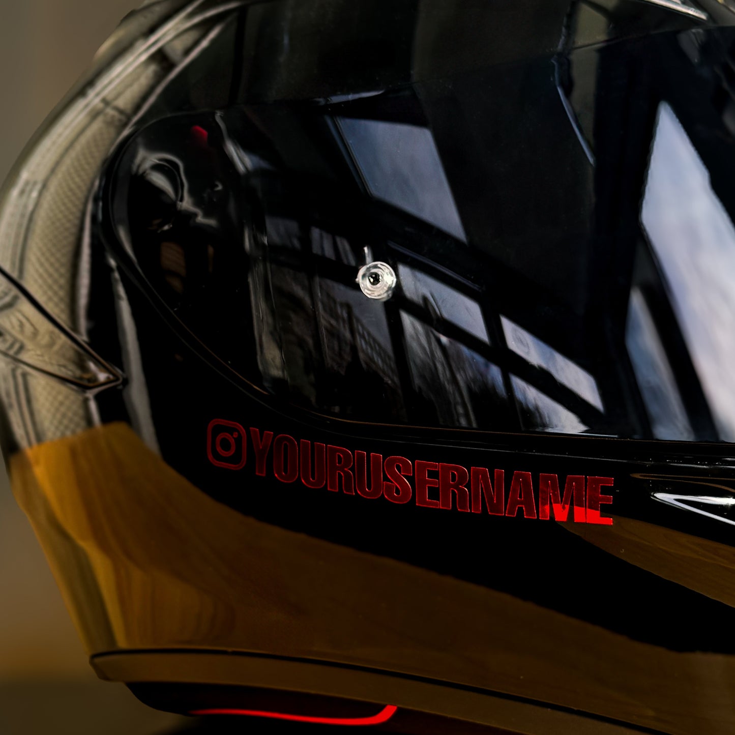 Black motorcycle helmet with a reflective visor and vinyl decal username