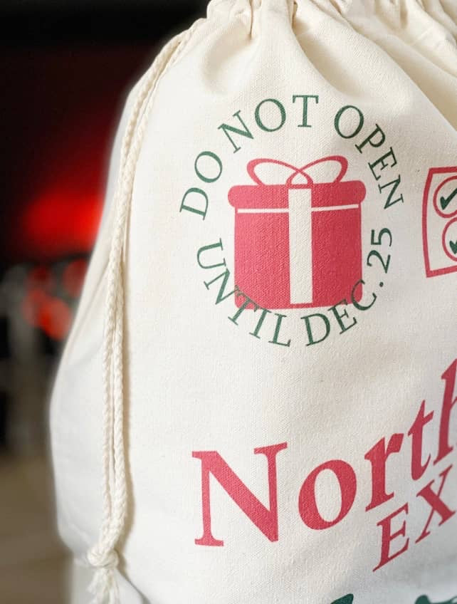 Santa sack printed Do Not Open Until Dec 25 with a red gift design