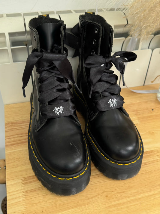 Black satin Sleep Token logo shoelaces threaded through black Jadon Dr. Martens boots, showing a bold and stylish custom footwear look.