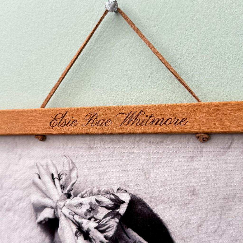 Wooden magnetic frame with engraved text hanging on a wall