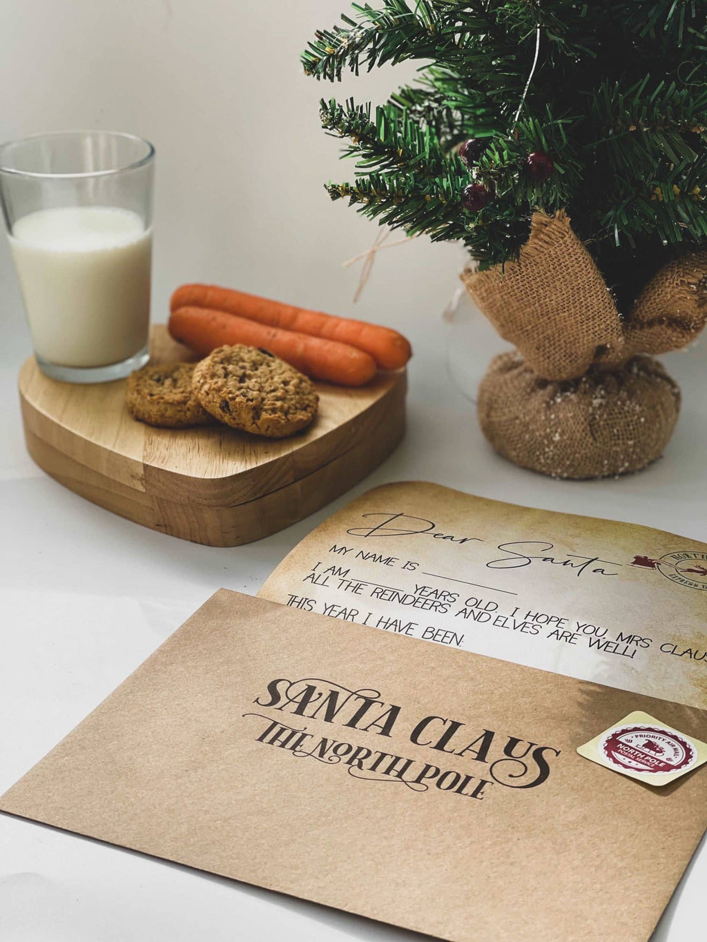 Letter to Santa kit beside milk, cookies and carrots for Christmas Eve
