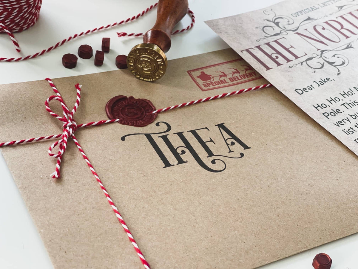 Wax-sealed kraft envelope addressed to Thea, tied with red and white twine