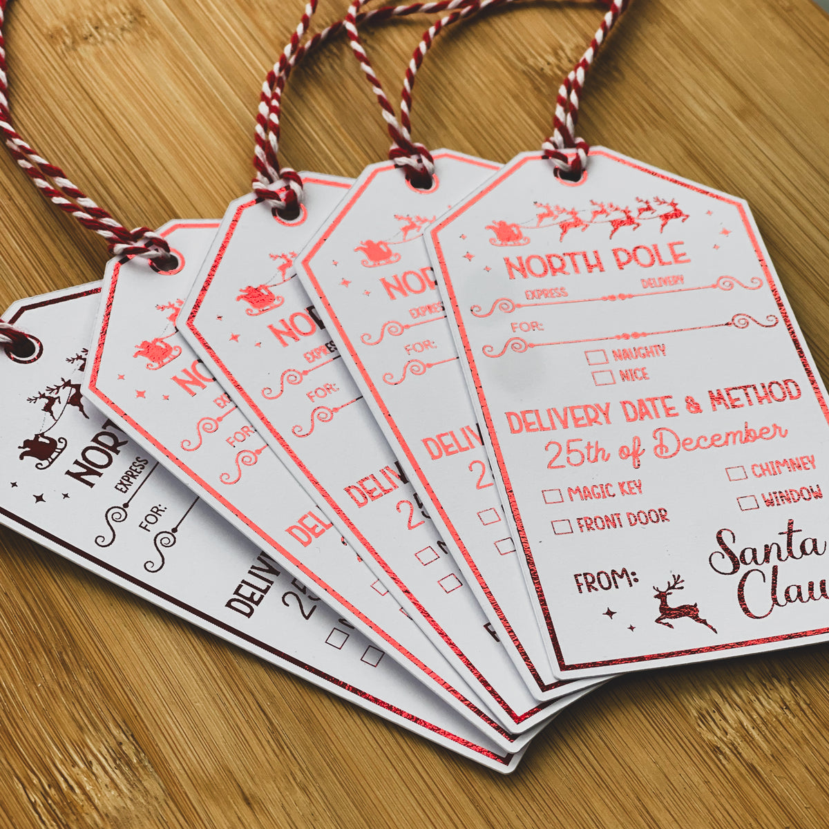 Set of North Pole gift tags with red and white twine