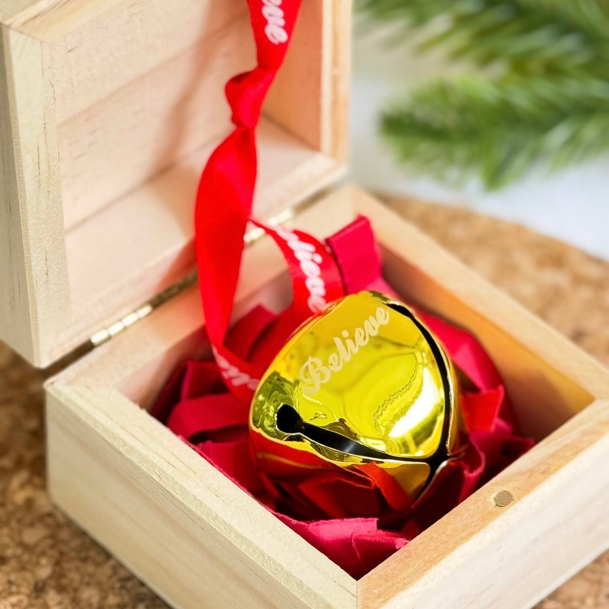 Christmas gold bell engraved ‘Believe’ in wooden gift box with red ribbon