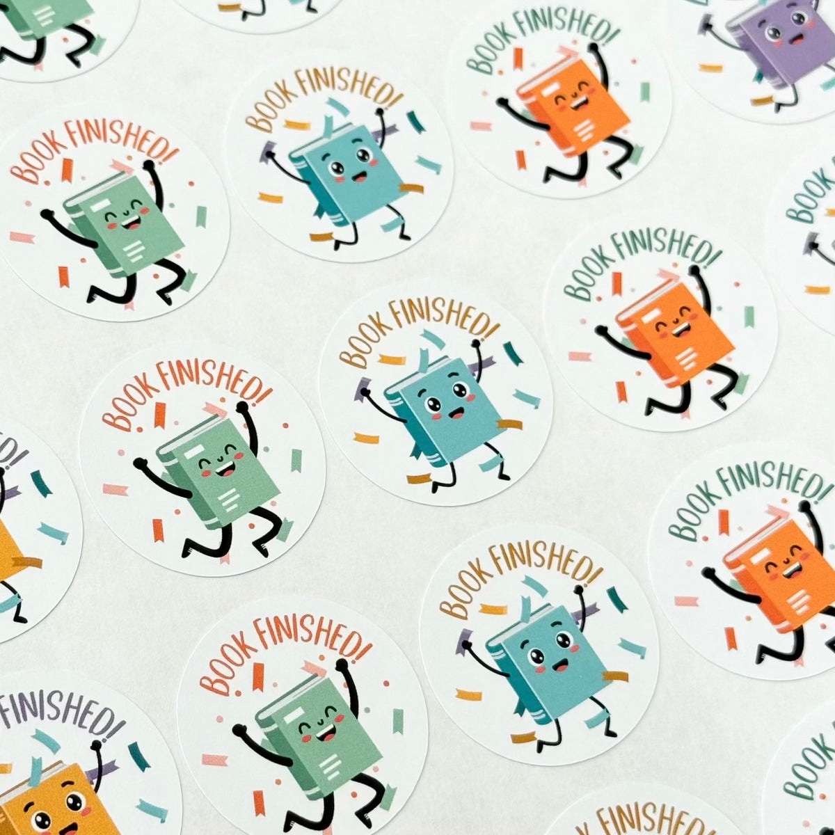 Set of stickers featuring cartoon books with ‘Book Finished!’ text, perfect for teachers, on white background