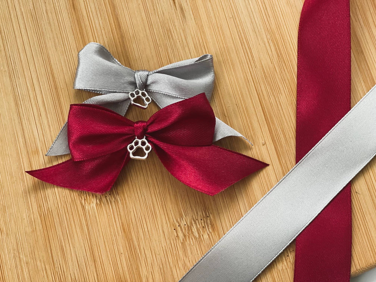 Red and grey bows with a paw print charm for a pet memorial bauble