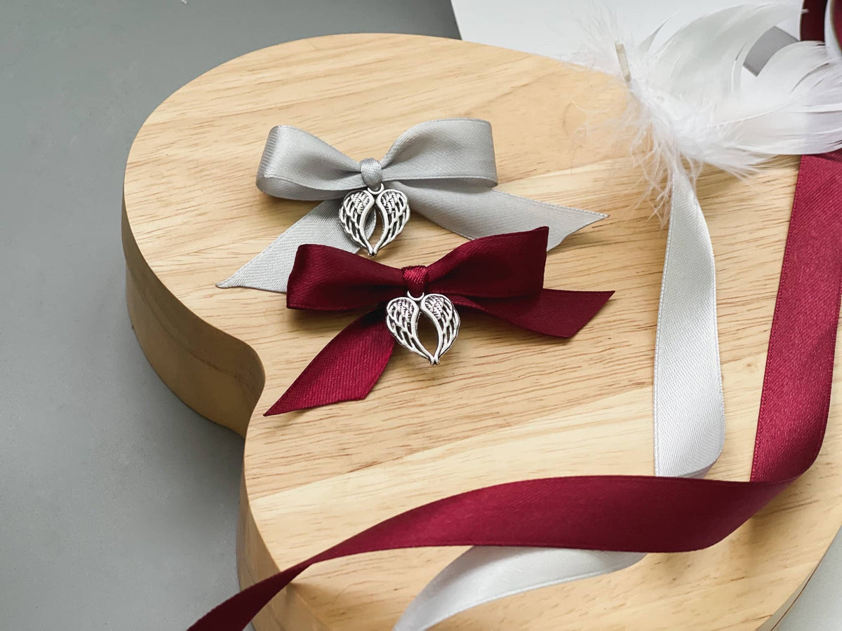 Burgundy and grey ribbon bows with angel wing charms for memorial baubles