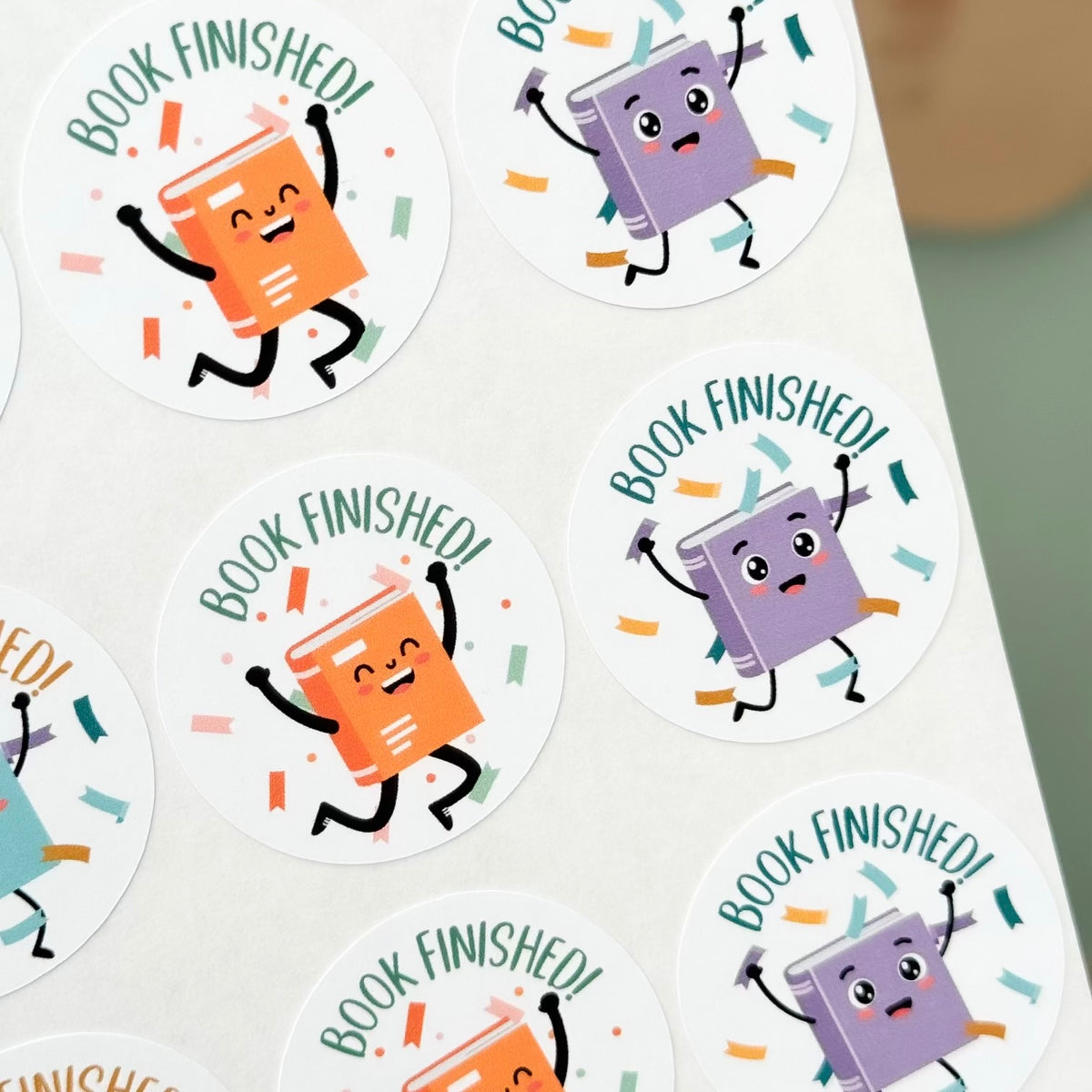 Stickers with cartoon books and 'Book Finished!' text on a white background