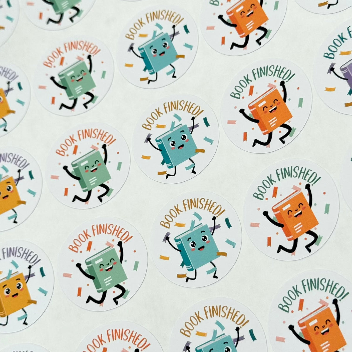 Stickers with cartoon books and 'Book Finished!' text on a white background