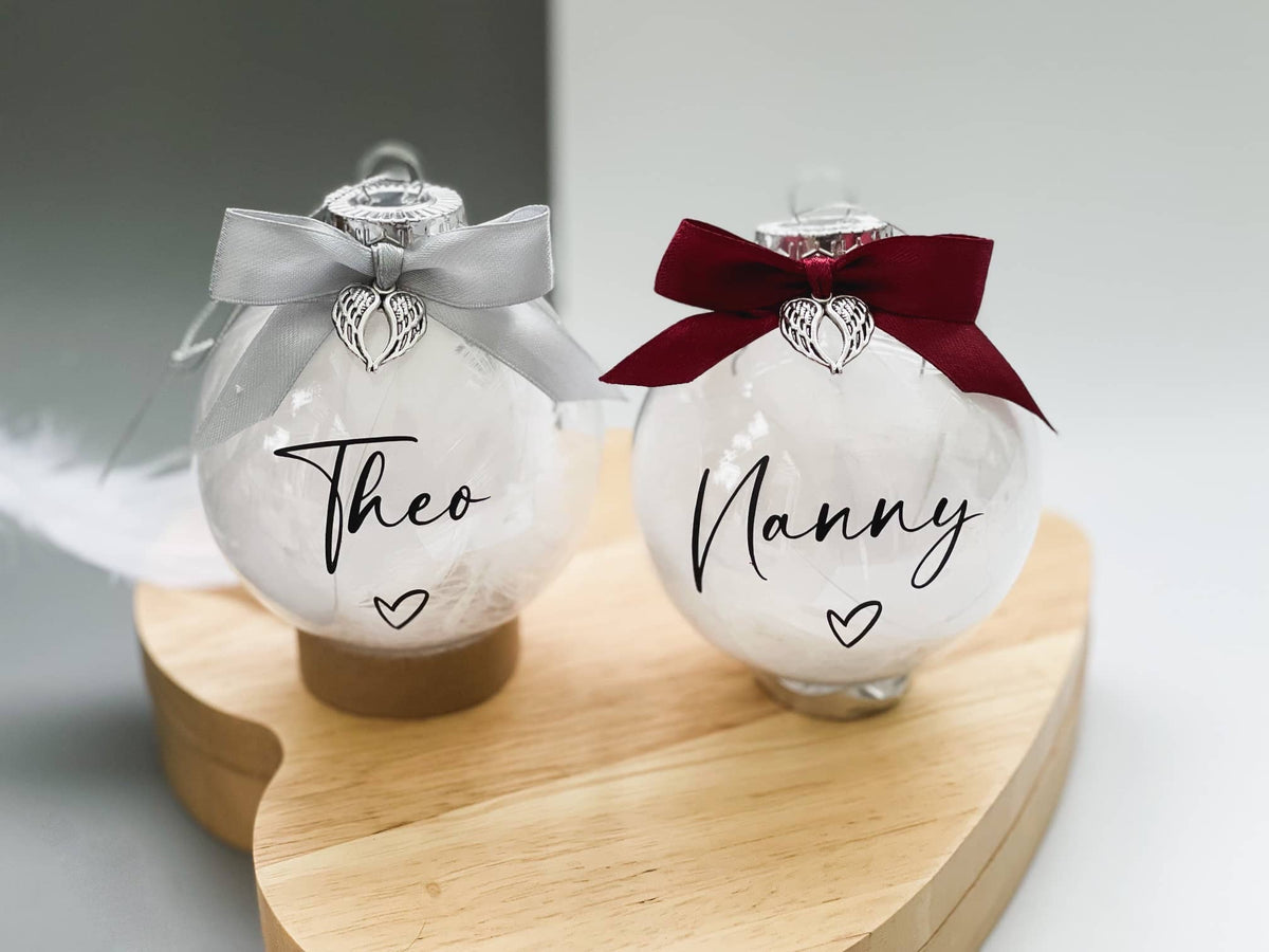 Two memorial baubles personalised with the names Theo and Nanny