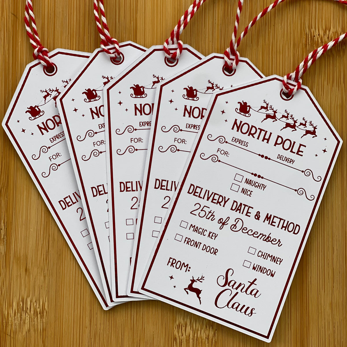 Fanned North Pole gift tags signed from Santa Claus