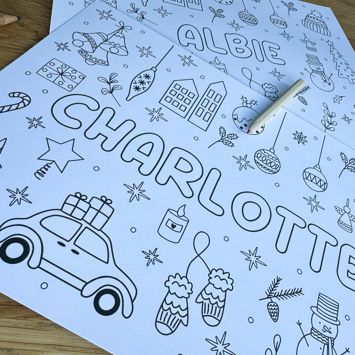 Close-up of a Christmas colouring placemat with the name Charlotte and a festive car