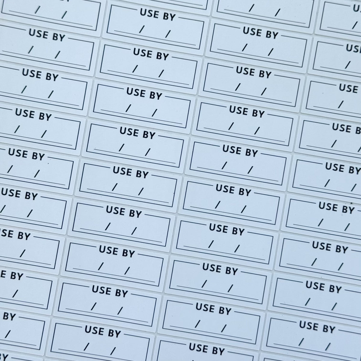 Close-up of Use By Date Labels on Food Storage Containers