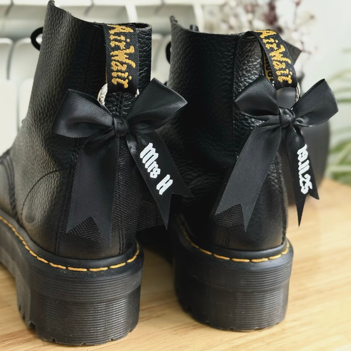 Black boots with personalised black bows featuring name and wedding date