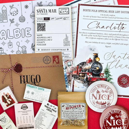 Collection of Christmas-themed letters, envelopes, and stationery items on a red background.