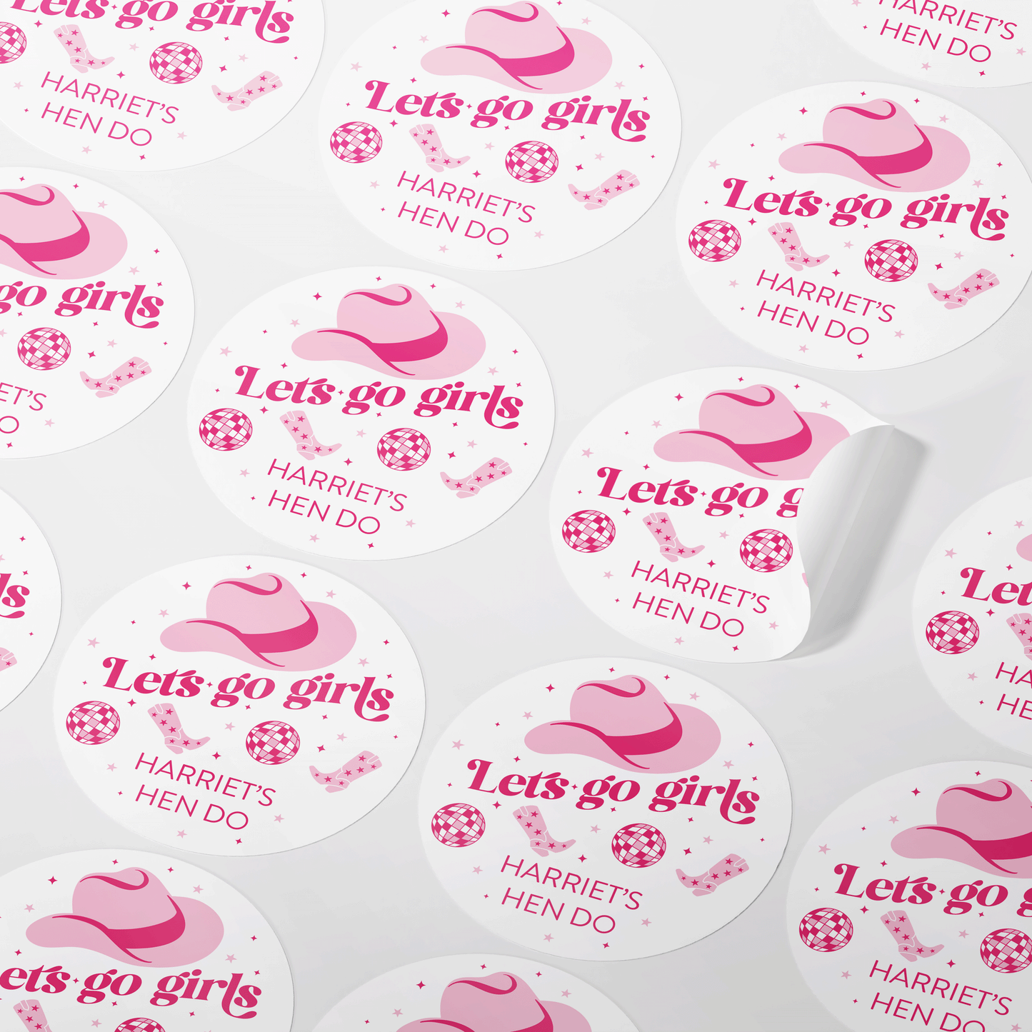 Round sticker with a pink cowboy hat and the text 'Let's go girls' in bold pink font. The design includes pink cowboy boots, disco balls, and stars, with 'Harriet's Hen Do' written at the bottom. Perfect for a fun, themed hen party