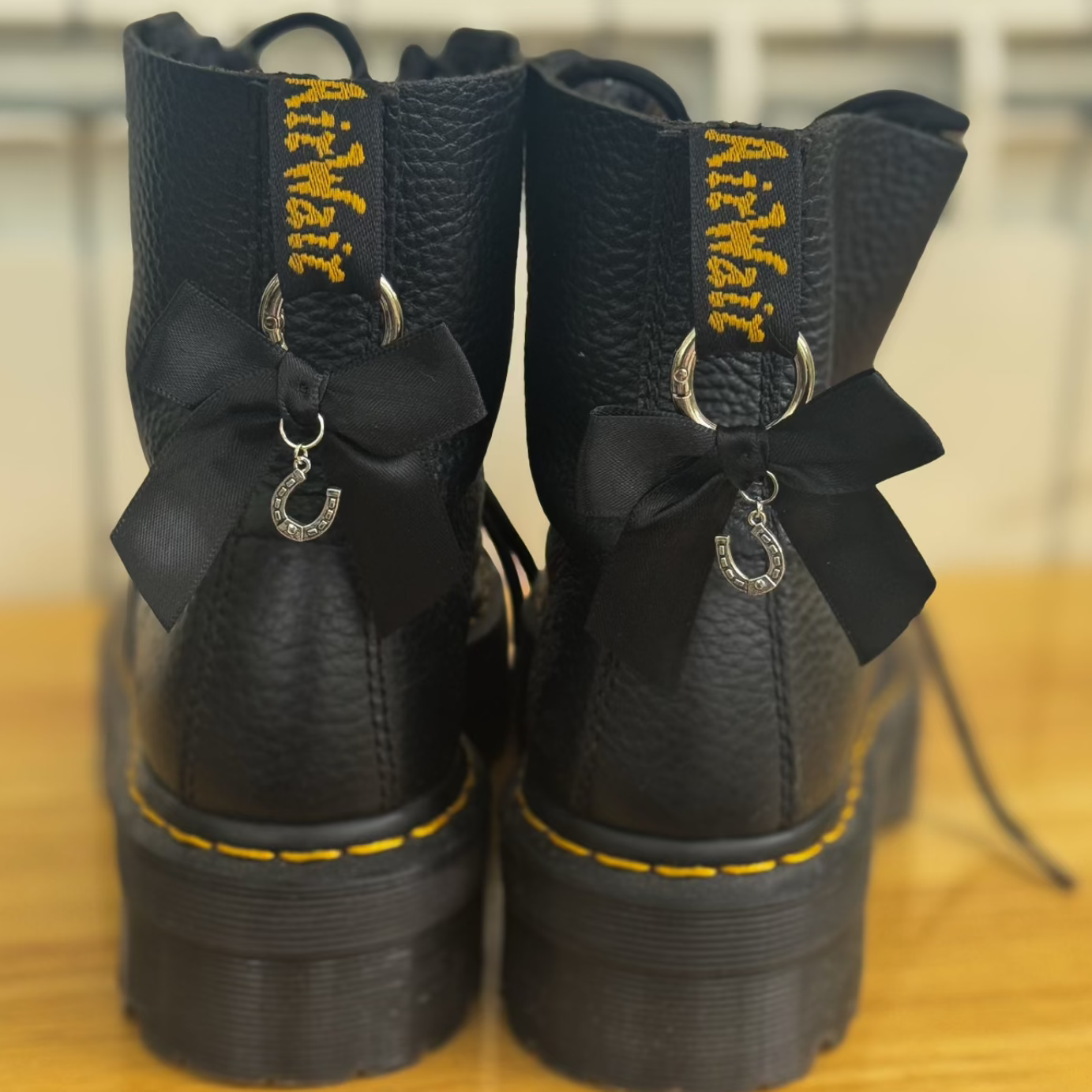 Black boots with bows and horse shoe charms