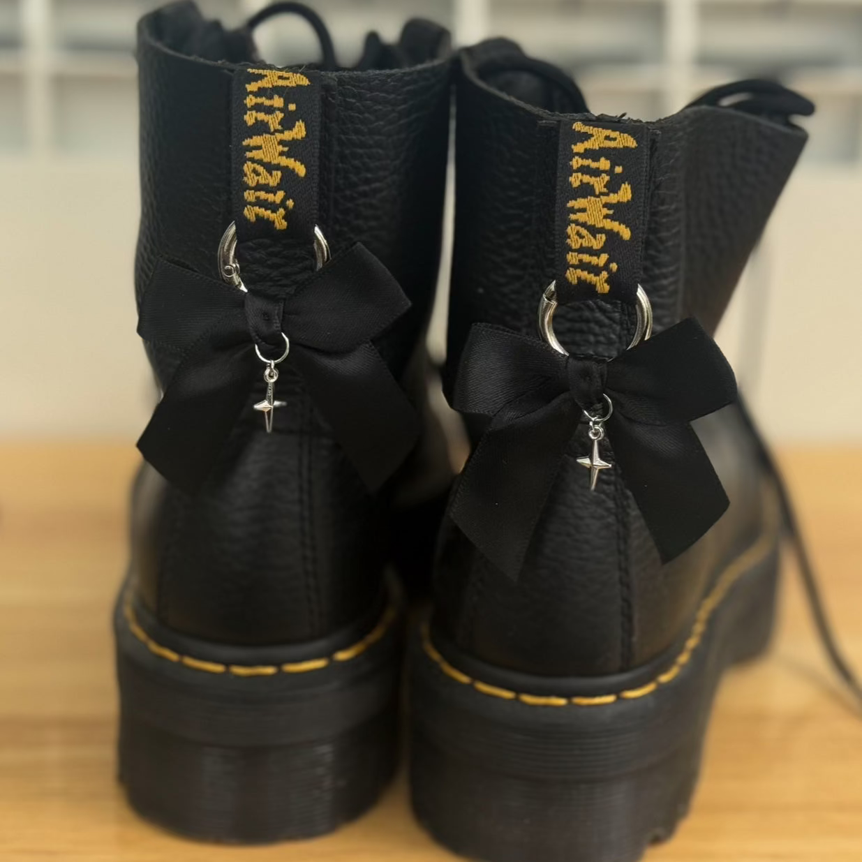 Black boots with decorative bows and glitter charms