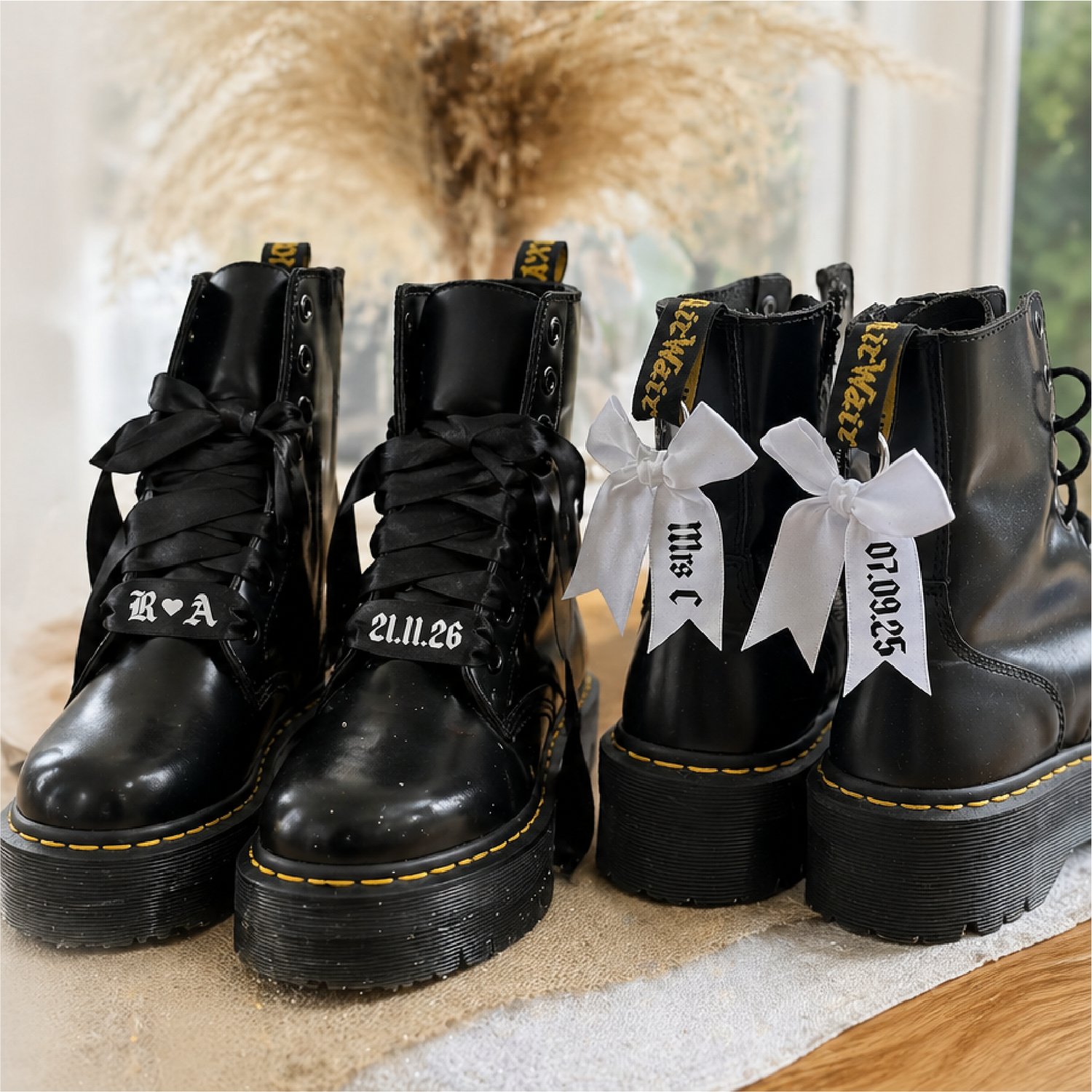 Black boots with white ribbons and text on a textured surface