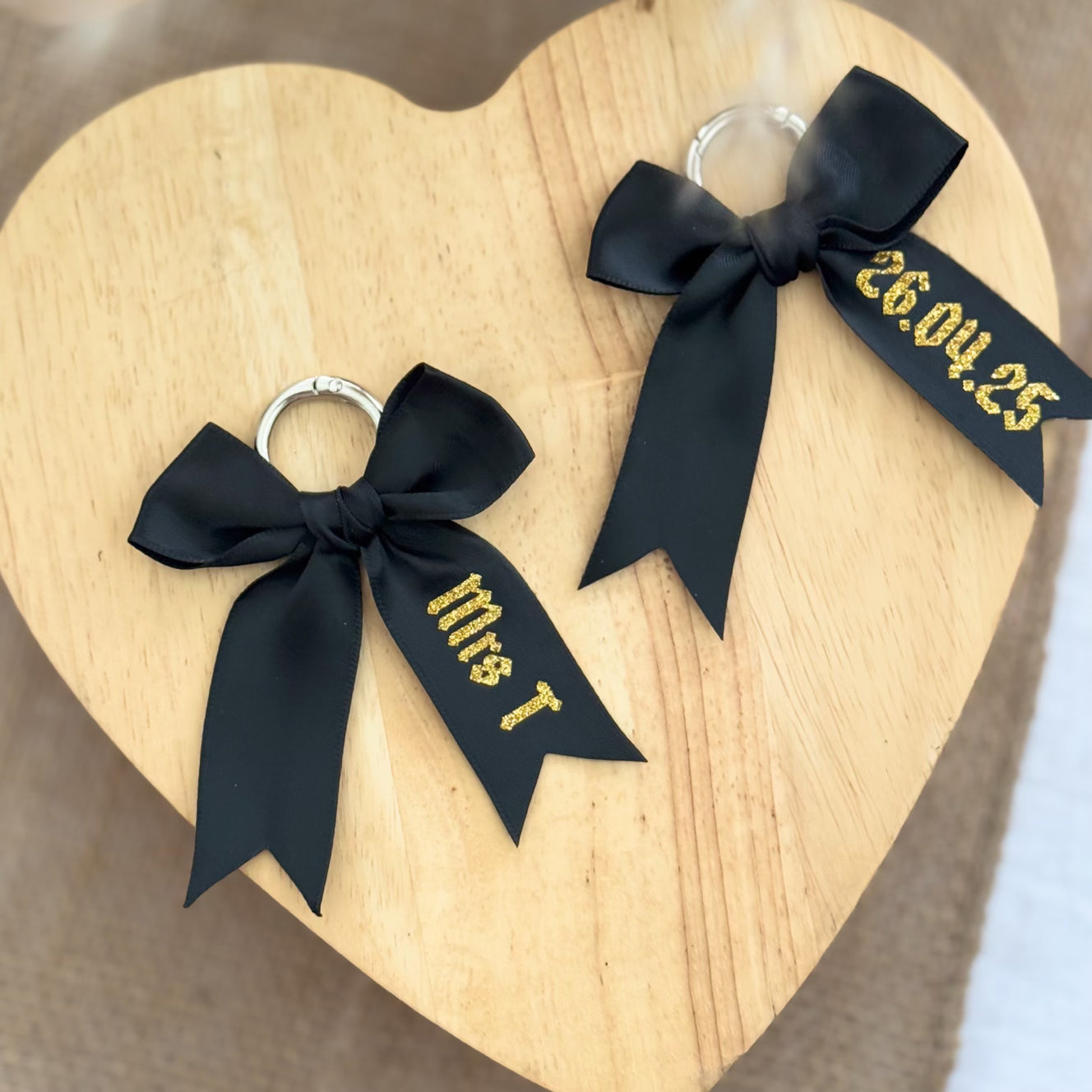 Custom black boot bows with gold glitter text for wedding boots